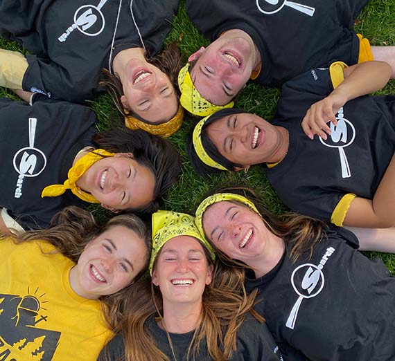 Closeup of people's faces in a circle.