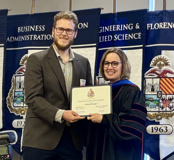 Nathaniel Shaffer with Dean Jacquie Van Hoomissen of the Gonzaga University College of Arts and Sciences holding an award at the 2025 Academic Honors and Magis Student Achievement Awards 