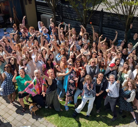 Attendees from the Dance 25th Anniversary Weekend in a group pose