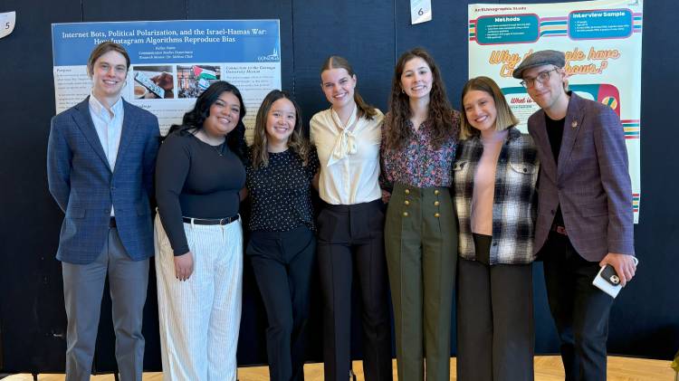 Morris Fellows standing in front of research posters