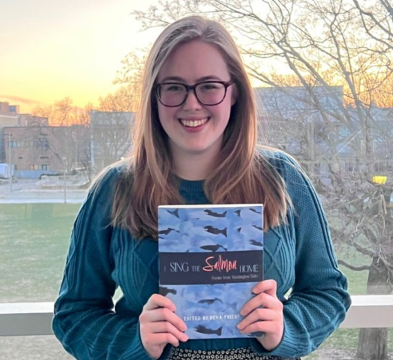 Meagan Graves holding the book "Sing the Salmon Home" 