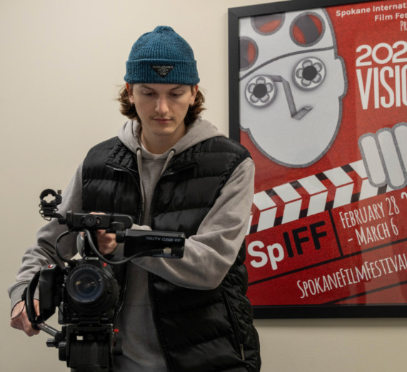 A student operating a tv camera.