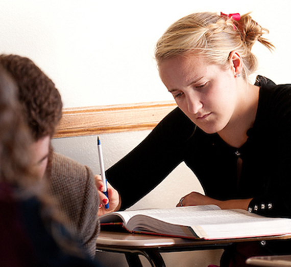 Student reading book in class.
