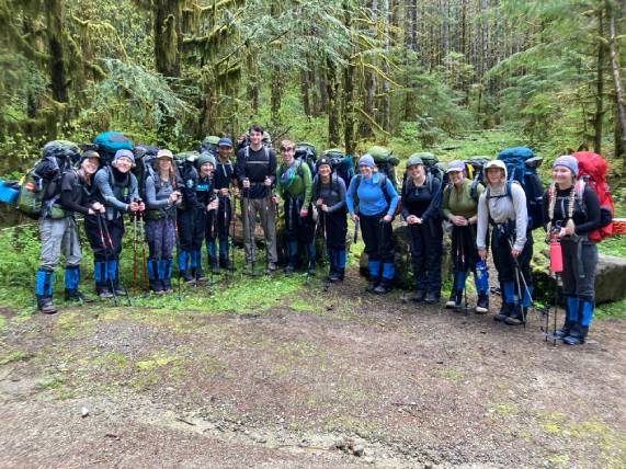 Gonzaga students in hiking gear on group hike in the woods