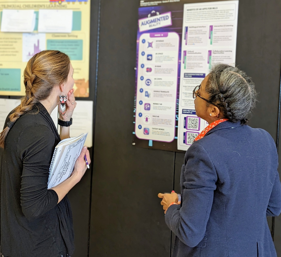 Two individuals looking at conference posters