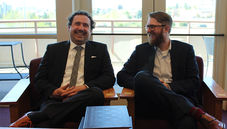 Law students Walter Tanner and Maxwell Bridge sitting and laughing