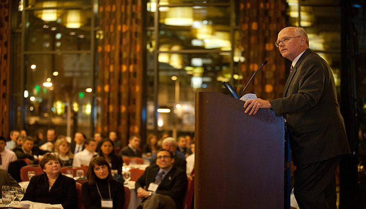 Speaker talks to a crowd at a Trek.