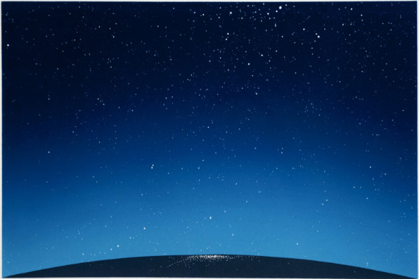 A black and blue night sky with stars.