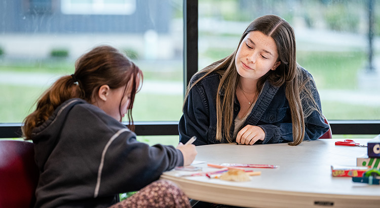 Gonzaga student works with a youth through CEL