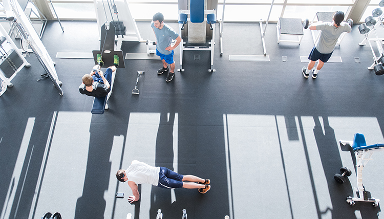 students lifting weights in the RFC weight room