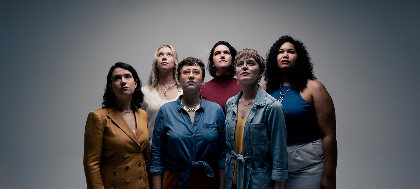 The members of Lyyra in a group looking up together. 