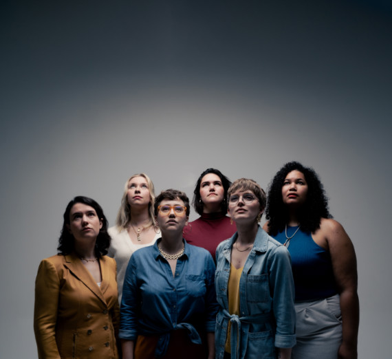 The group Lyyra posed together looking up. 