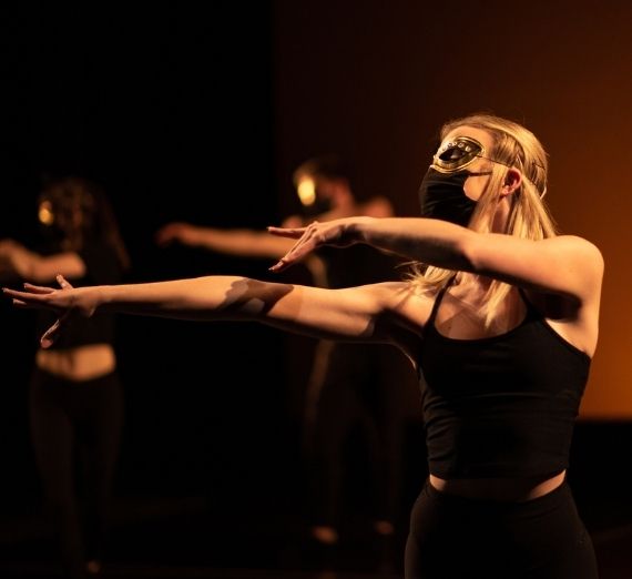 Dancer in a mask posing elegantly