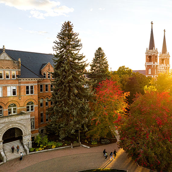 Arial view of College Hall with St. Aloysius church spires in the background.