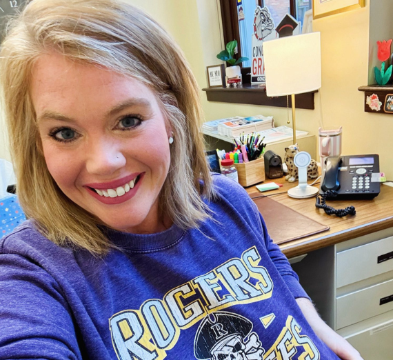 School Psychology student Lauren poses in her Rogers spirit shirt