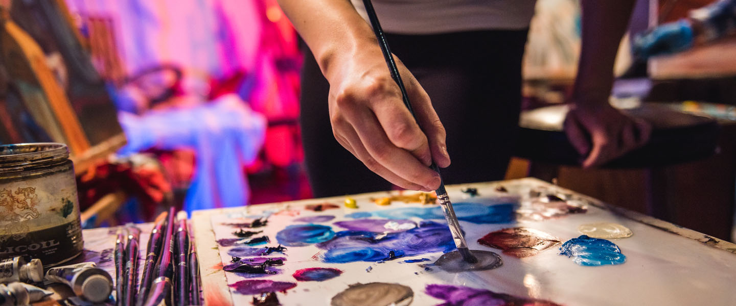 Student painting in class