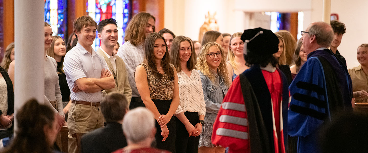 Students stand in College Hall Chapel during Gonzaga University’s Phi Beta Kappa inauguration ceremony.