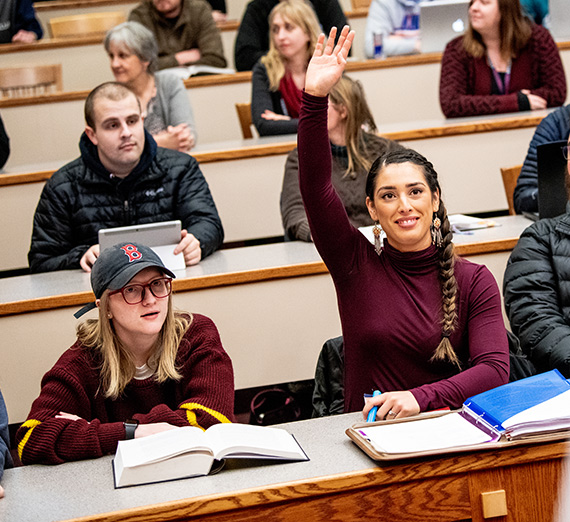student raising hand in class