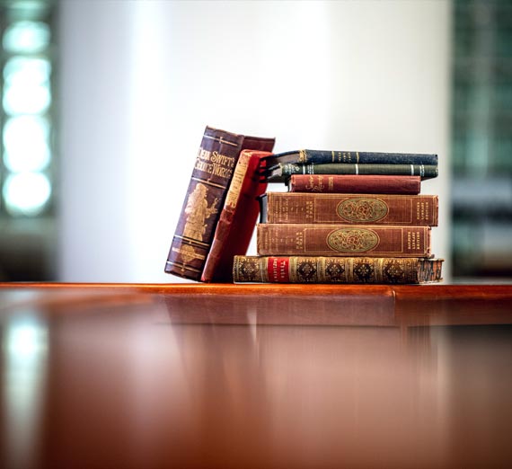 Old books stacked on a desk in Gonzaga University's rare books room