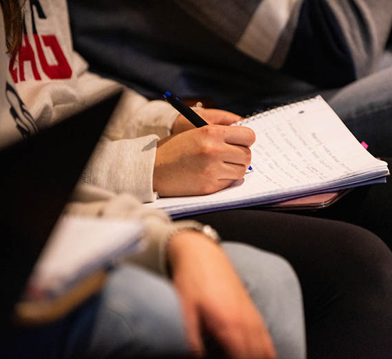 Student taking notes.