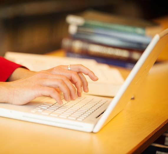 Person typing on a laptop.