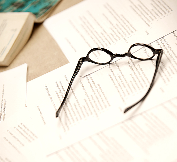Glasses on a table covered in paper