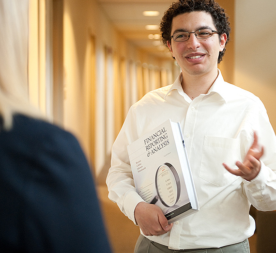 An undergraduate accounting student speaks with a professor