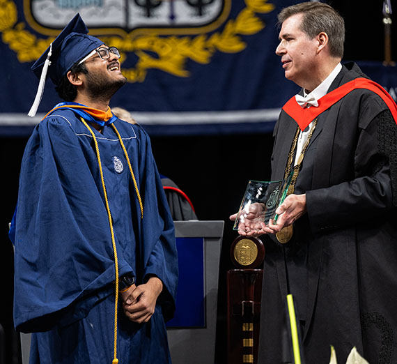 Suyash Kushwaha receives award from president Thayne Mcculloh