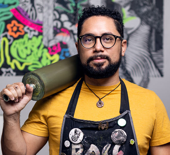 Reinaldo Gil Zambrano holding a screen printing roller
