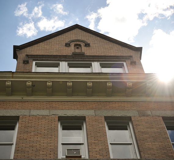 The sun and the clouds over College Hall