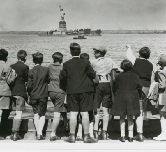 Children aboard the President Harding look at the Statue of Liberty as they pull into New York Harbor.