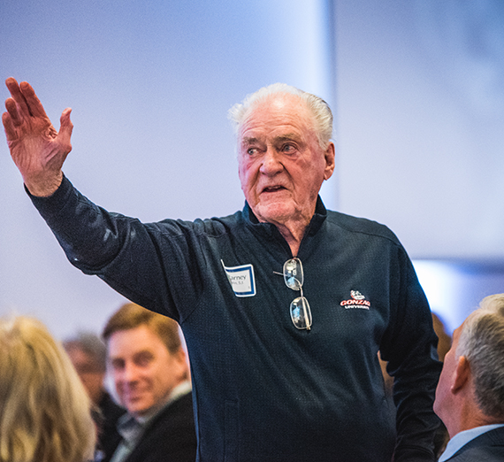 Father Coughlin waves