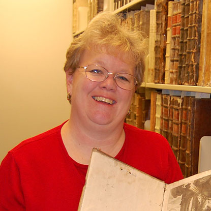 Stephanie Plowman by very old books in the Foley vault
