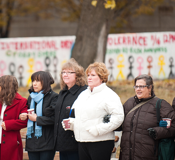 women standing together holding hands