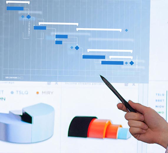 Hand holding a pen pointing to a screen