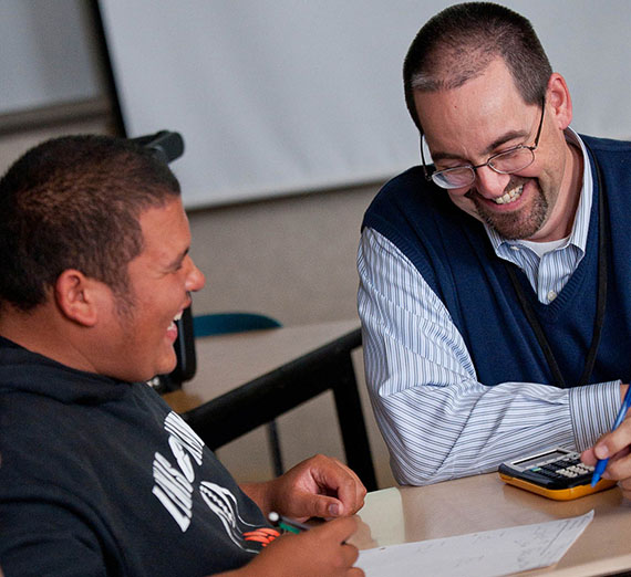 Teacher laughing with student