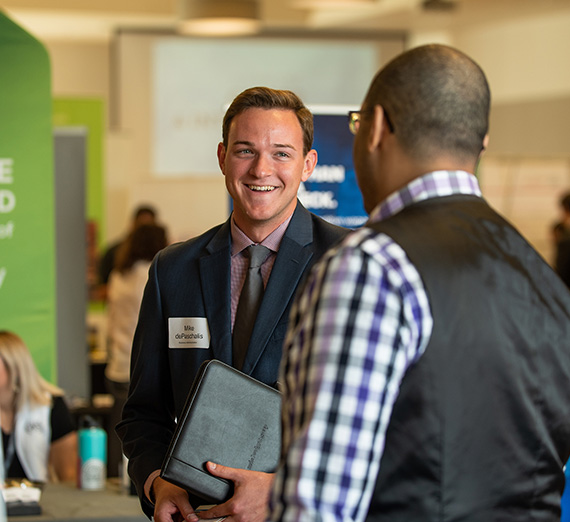 Two individual chat at a career fair