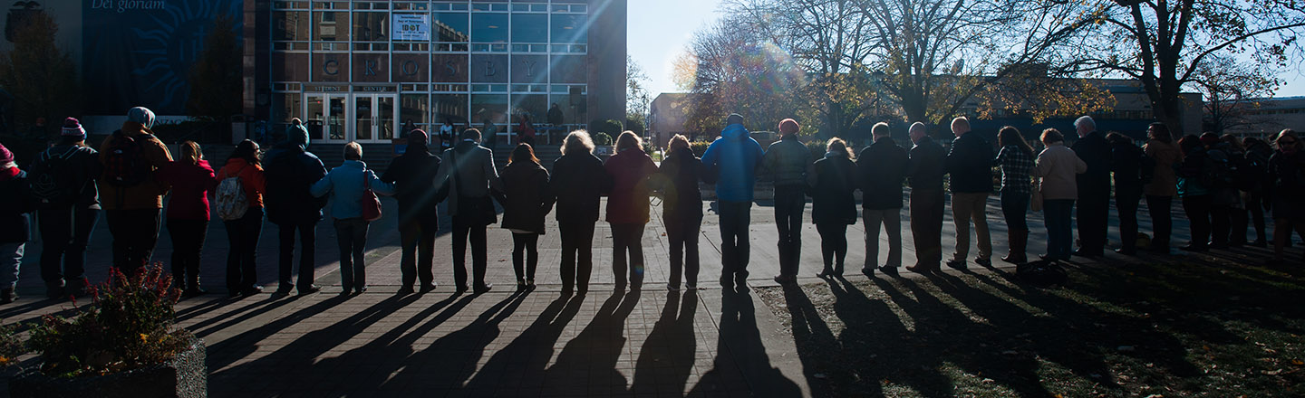 Students and faculty gather outside of the Crosby Center by the wall to recognize International Day of Tolerance.