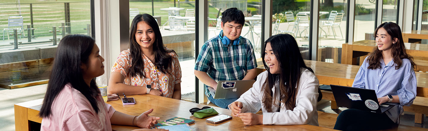 A group of international students gathers for a study session.