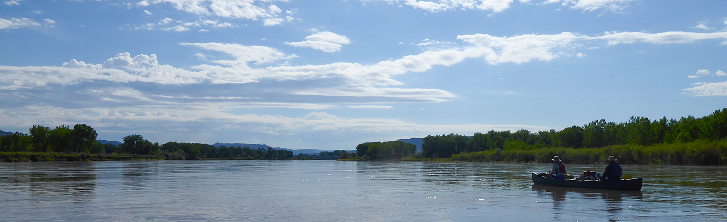 Environmental scientists in a canoe on a lake.
