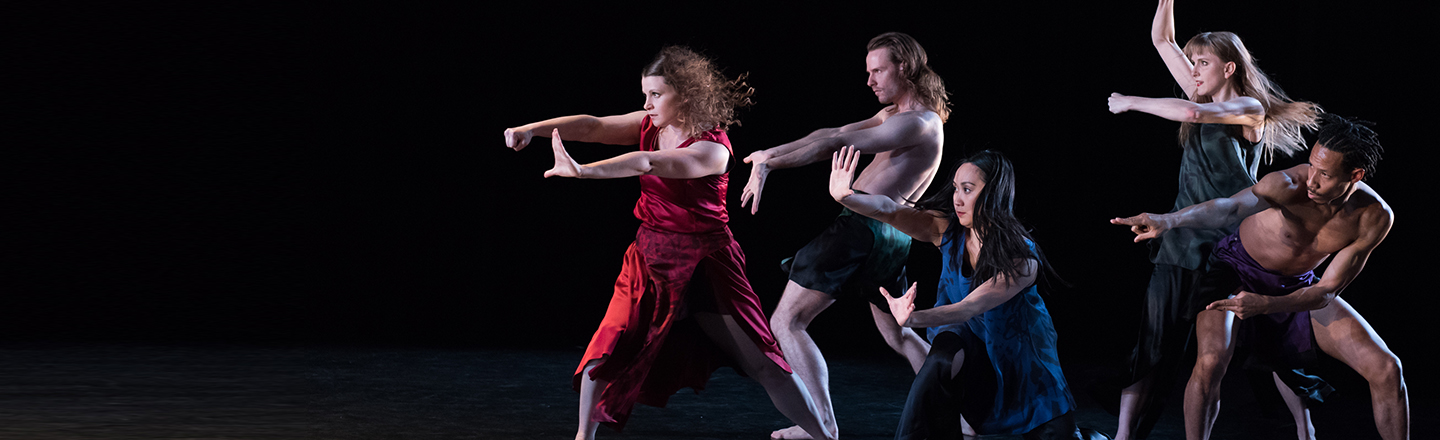 Group of dancers point from right side to left side.