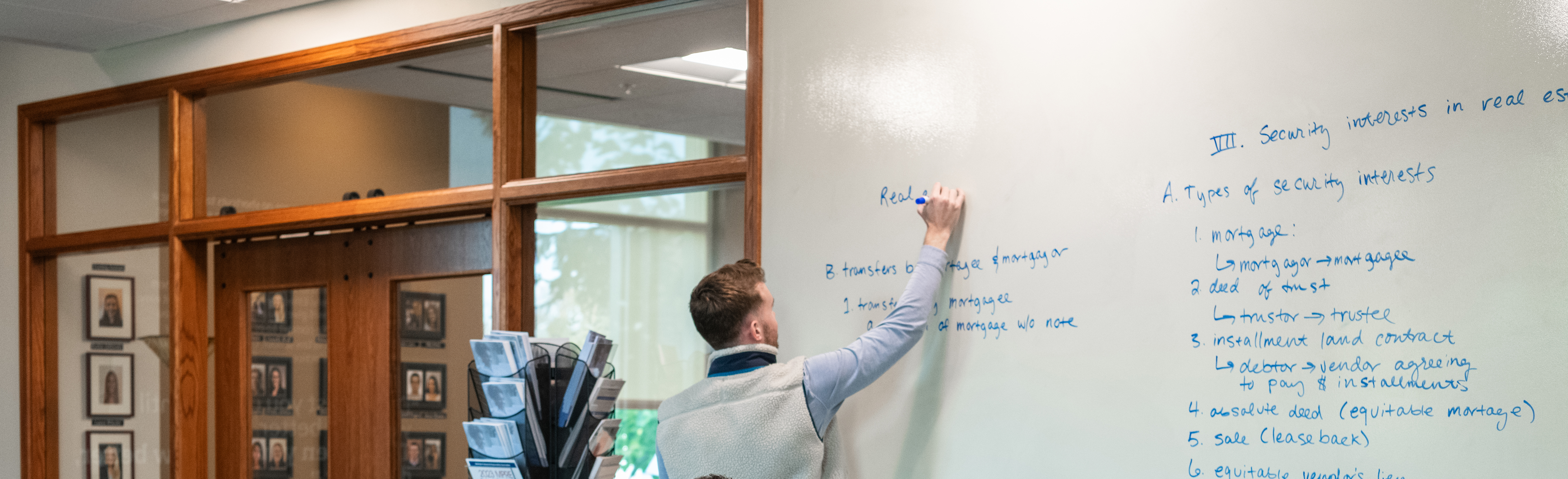 Law student writing on the board during a study session.
