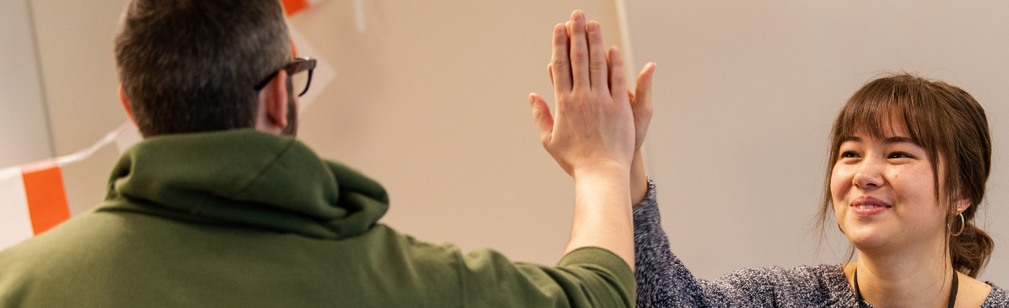 Two teachers high five.