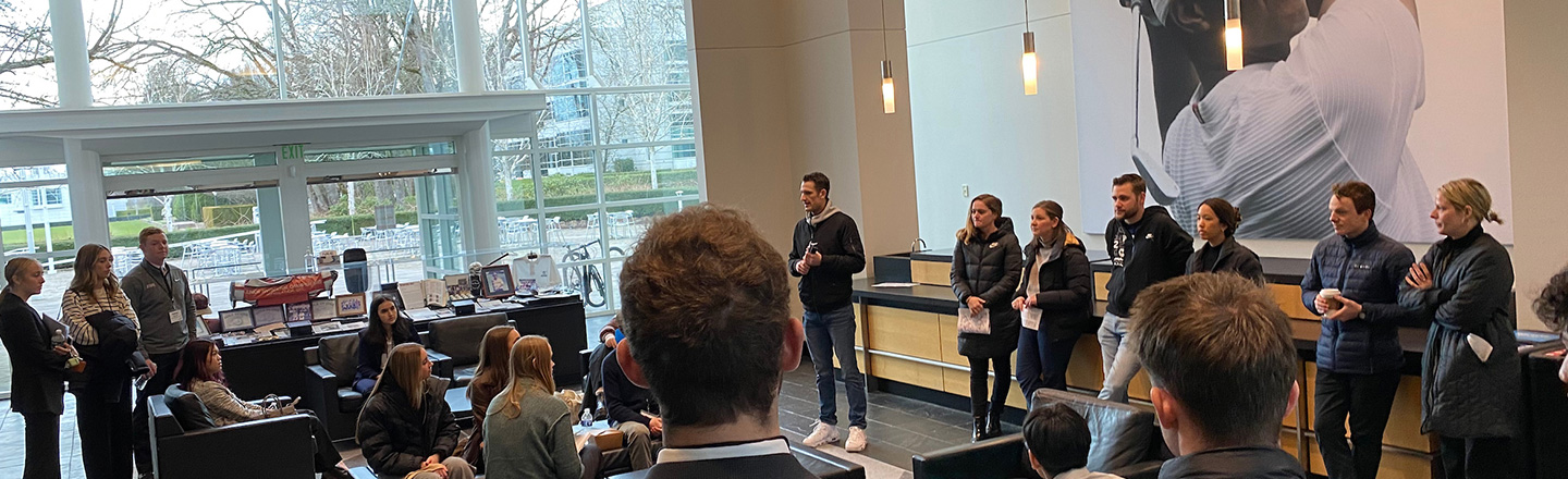students surrounding presenter at a corporate visit 
