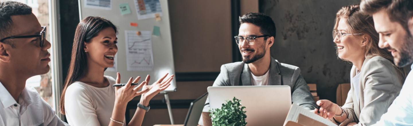 A group of businesspeople talking over a table