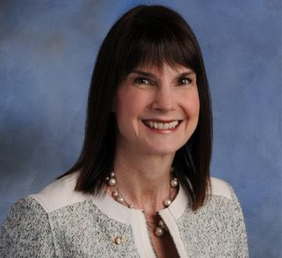Headshot of Andy Schneider against muddy blue background