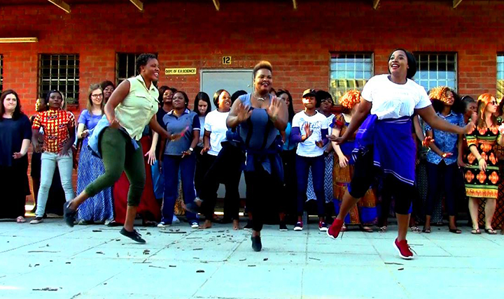 Gonzaga University choir members watch Zambian musicians dance in Africa