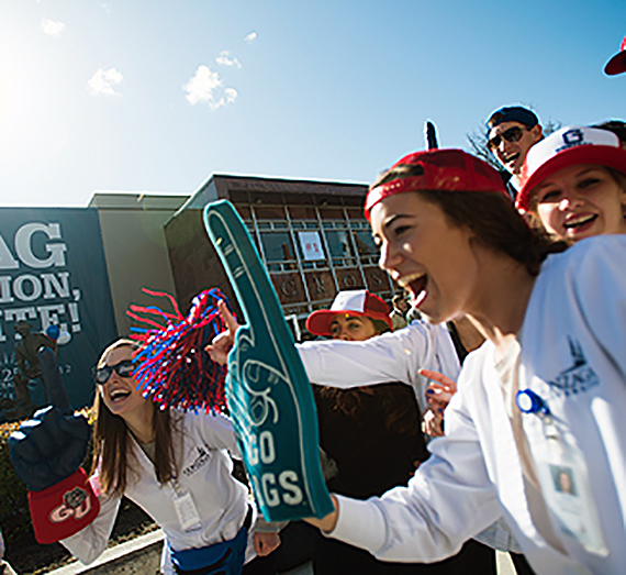 Gonzaga students with foam finger and zag gear outside of Hemmingson building.