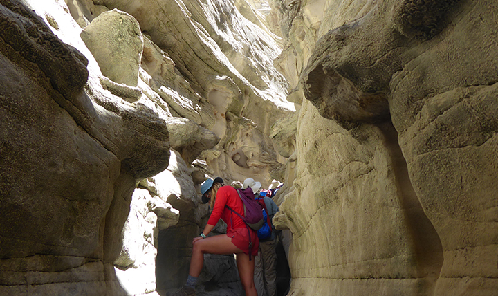 Student walks through a slot canyon