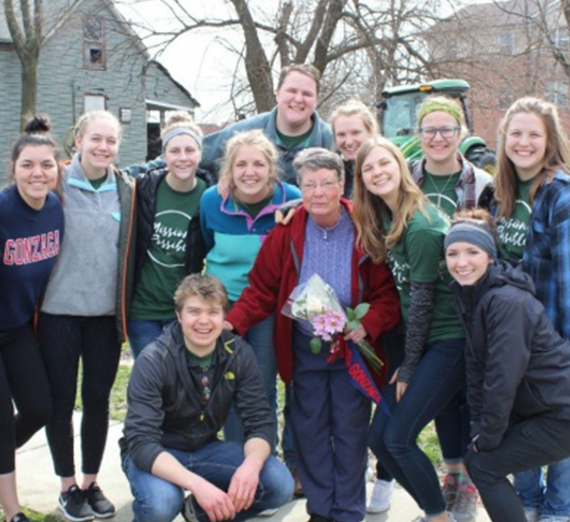 A group poses with Miss Paulyn, who started a street outreach program in St. Louis. 